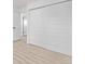 Bedroom featuring light wood flooring, bright natural light from window, and closet with sliding doors at 16555 E Wesley Ave, Aurora, CO 80013