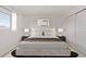 Bedroom features a large window, neutral decor, and a modern upholstered bed frame at 16555 E Wesley Ave, Aurora, CO 80013