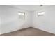 Bright bedroom featuring neutral carpet, white walls, and two windows for ample natural light at 16555 E Wesley Ave, Aurora, CO 80013