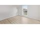 Bright bedroom featuring a large window, light wood flooring, and clean white walls at 16555 E Wesley Ave, Aurora, CO 80013