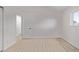 Bedroom with light wood floor, door to closet on left, and bright natural light from window at 16555 E Wesley Ave, Aurora, CO 80013
