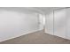 Clean bedroom featuring neutral carpet, white walls, and closet doors at 16555 E Wesley Ave, Aurora, CO 80013