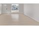 Bright and airy empty room featuring light hardwood flooring and a large window at 16555 E Wesley Ave, Aurora, CO 80013