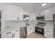 Modern kitchen features white cabinets, stainless appliances, and marble countertops at 16555 E Wesley Ave, Aurora, CO 80013