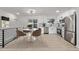 Modern kitchen with stainless steel appliances, white cabinetry, and an adjacent dining area at 16555 E Wesley Ave, Aurora, CO 80013