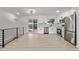 Open kitchen with stainless steel appliances, light wood floors and slider to deck at 16555 E Wesley Ave, Aurora, CO 80013