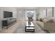 Bright living room featuring modern furnishings, light wood floors, and a large window for ample natural light at 16555 E Wesley Ave, Aurora, CO 80013