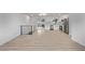 Open living area showcasing modern railings, light wood floors, and a sleek, stainless steel refrigerator at 16555 E Wesley Ave, Aurora, CO 80013