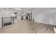 Open living area with modern railings, light wood floors, and a view into the kitchen area at 16555 E Wesley Ave, Aurora, CO 80013