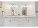 Elegant bathroom features dual sinks, marble countertops, and modern lighting at 1274 Meyerwood Ln, Highlands Ranch, CO 80129