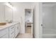 Bright white bathroom featuring tub, shower, and updated vanity with marble counter at 1274 Meyerwood Ln, Highlands Ranch, CO 80129