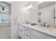 Modern bathroom featuring double vanity with marble counters and updated fixtures at 1274 Meyerwood Ln, Highlands Ranch, CO 80129