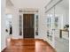 Bright and open foyer with hardwood floors, a view of the staircase, and a glimpse of other rooms at 1274 Meyerwood Ln, Highlands Ranch, CO 80129