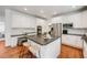 Modern kitchen featuring a kitchen island with seating, stainless steel appliances, and wood floors at 1274 Meyerwood Ln, Highlands Ranch, CO 80129