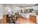 Spacious kitchen with a dining area features stainless steel appliances and modern white cabinets at 1274 Meyerwood Ln, Highlands Ranch, CO 80129