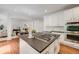 Modern kitchen features a large island with cooktop, white cabinetry, and stainless steel appliances at 1274 Meyerwood Ln, Highlands Ranch, CO 80129