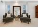 Living room featuring matching armchairs, a mirror, and bright, natural lighting at 1274 Meyerwood Ln, Highlands Ranch, CO 80129