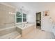 Well-lit primary bathroom with a soaking tub, glass shower, and walk-in closet at 1274 Meyerwood Ln, Highlands Ranch, CO 80129