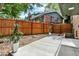 A large concrete patio and wood privacy fence create a welcoming outdoor space at 400 S Hoyt St, Lakewood, CO 80226