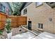 Basement access and a tall privacy fence add unique features to the cozy, rock-landscaped backyard at 400 S Hoyt St, Lakewood, CO 80226