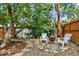 Backyard featuring mature trees, stone pavers, and outdoor seating area with fire pit at 400 S Hoyt St, Lakewood, CO 80226