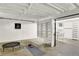 Unfinished basement area ideal for gym with open ceiling, yoga mat, and desk with storage at 400 S Hoyt St, Lakewood, CO 80226