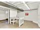 Finished basement featuring concrete floors, pegboard, and fluorescent lighting at 400 S Hoyt St, Lakewood, CO 80226
