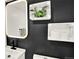 Stylish powder room featuring black accent wall, sleek white vanity, lighted mirror and modern shelving at 400 S Hoyt St, Lakewood, CO 80226