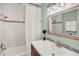 Updated bathroom showcasing a vanity, tub and shower with decorative tile at 400 S Hoyt St, Lakewood, CO 80226