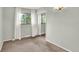 Inviting bedroom with carpet, large window, white curtains, and mirrored closet at 400 S Hoyt St, Lakewood, CO 80226