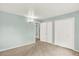 Bedroom boasting neutral carpet, a wall light fixture, and storage closet at 400 S Hoyt St, Lakewood, CO 80226