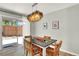 Inviting dining area with stylish light fixture, table set for four, and sliding glass doors to outdoor patio at 400 S Hoyt St, Lakewood, CO 80226