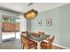 Dining area with modern chandelier, seating for four, and sliding glass door to backyard at 400 S Hoyt St, Lakewood, CO 80226