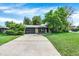Long driveway leads to a two-car garage, with well-kept lawn and established landscaping at 400 S Hoyt St, Lakewood, CO 80226