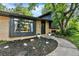 Brick home with black accents and lush front yard plants create a welcoming feel at 400 S Hoyt St, Lakewood, CO 80226