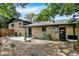 Exterior view of the home with brick facade, sliding glass door, and landscaped backyard at 400 S Hoyt St, Lakewood, CO 80226