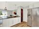 Open kitchen featuring a breakfast bar, stainless steel fridge, and access to the living room at 400 S Hoyt St, Lakewood, CO 80226