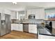 Modern kitchen features white cabinets, stainless steel appliances, and sleek black countertops at 400 S Hoyt St, Lakewood, CO 80226
