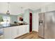 Updated kitchen with stainless steel refrigerator and access to the living room at 400 S Hoyt St, Lakewood, CO 80226