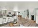 Bright, open kitchen next to stairs and dining area, with a breakfast bar and stainless appliances at 400 S Hoyt St, Lakewood, CO 80226