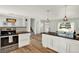 Open kitchen with stainless steel oven, island, and access to the entry hall at 400 S Hoyt St, Lakewood, CO 80226