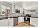 Bright kitchen with white cabinets, stainless steel appliances, and sleek black countertops at 400 S Hoyt St, Lakewood, CO 80226