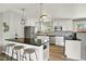 Modern kitchen featuring stainless steel appliances, white cabinetry, and a breakfast bar at 400 S Hoyt St, Lakewood, CO 80226