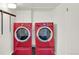 Convenient laundry area with updated red front-loading washer and dryer units at 400 S Hoyt St, Lakewood, CO 80226