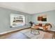 Bright living room featuring a large window, wood floors, and stylish decor at 400 S Hoyt St, Lakewood, CO 80226