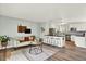 Open-concept floor plan with living room, kitchen island, and bar stools for seamless entertaining at 400 S Hoyt St, Lakewood, CO 80226
