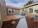 Private back patio with wood deck, concrete slab, and two blue chairs at 7101 W Yale Ave # 1206, Denver, CO 80227