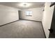 Basement features neutral carpet, white walls, and natural light at 7101 W Yale Ave # 1206, Denver, CO 80227