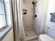 Modern bathroom showcases a tiled shower with niche and black fixtures near window at 7101 W Yale Ave # 1206, Denver, CO 80227