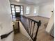 Inviting entryway featuring a staircase, bright lighting, and views of the living area at 7101 W Yale Ave # 1206, Denver, CO 80227